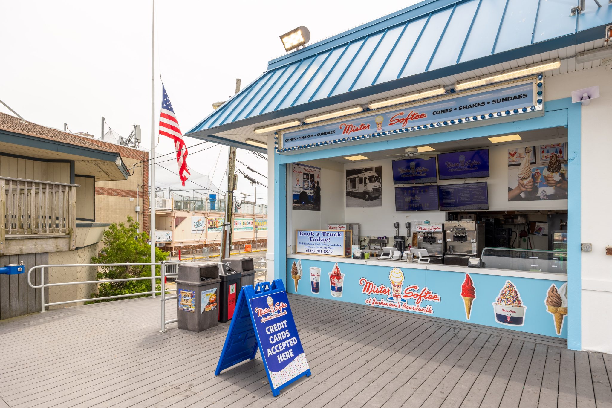 The front of Mister Softee at Jenkinson's Boardwalk in Point Pleasant Beach New Jersey with digital signs and images of ice cream cones and shakes