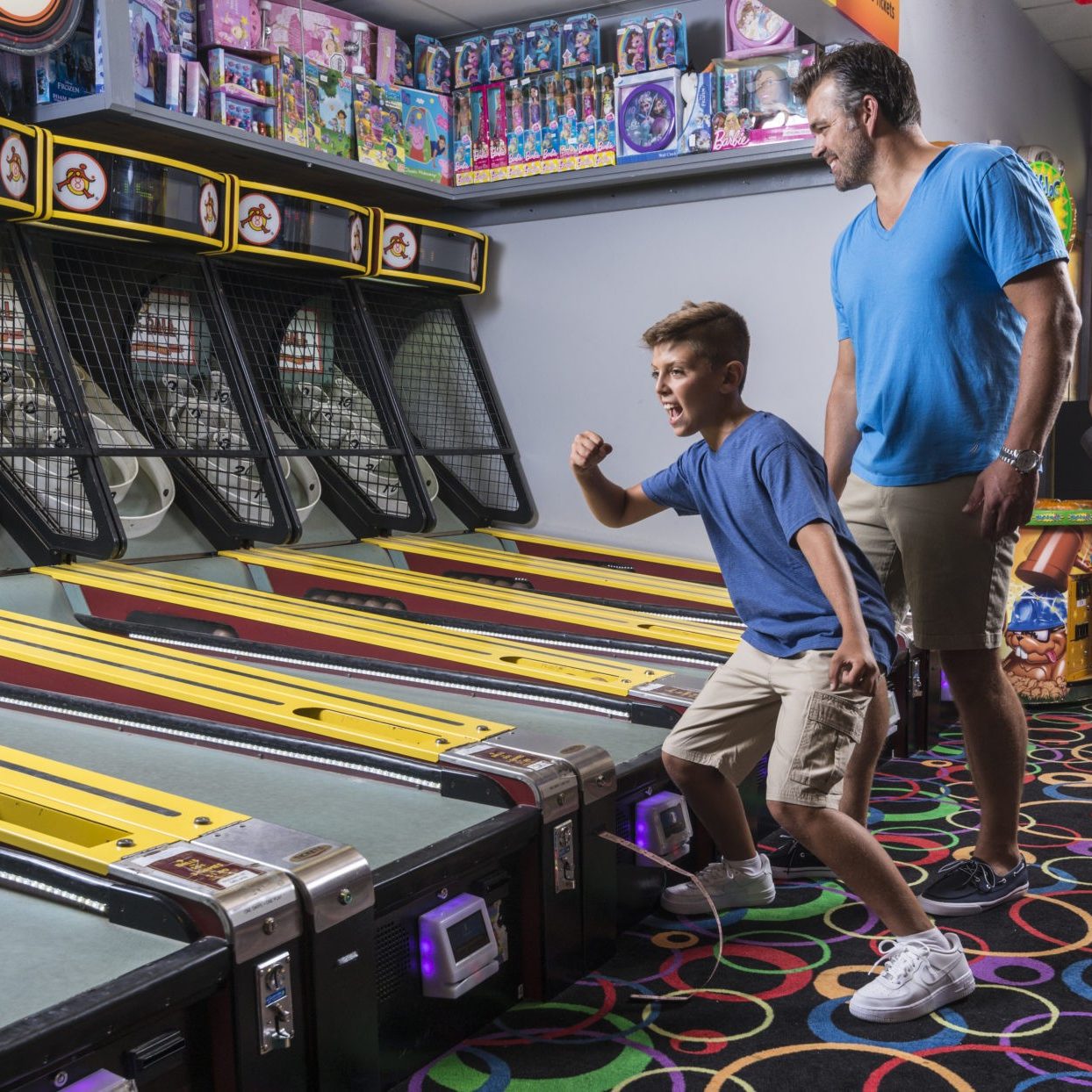 Photo of Jenkinson's Arcade with people playing skiball.